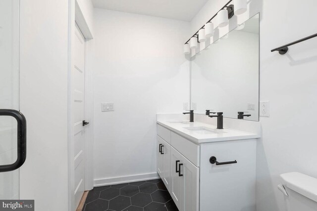 bathroom with tile floors, toilet, and oversized vanity