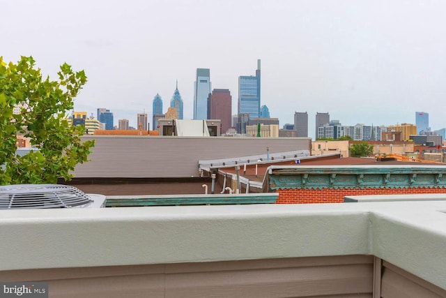 view of terrace with central AC unit and a balcony