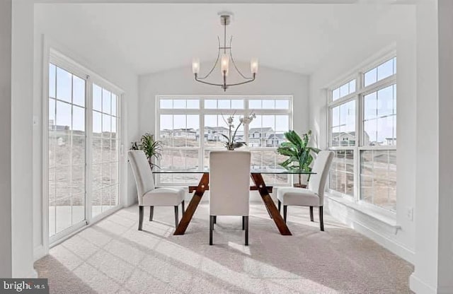 sunroom featuring lofted ceiling, a notable chandelier, and a wealth of natural light