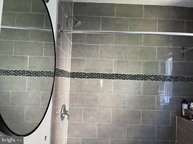 bathroom with a tile shower