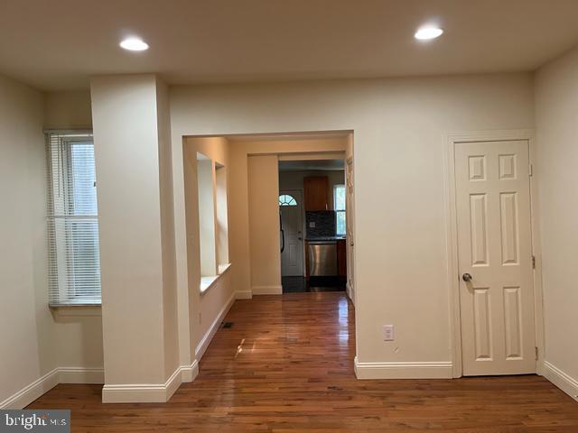 hall with dark hardwood / wood-style flooring