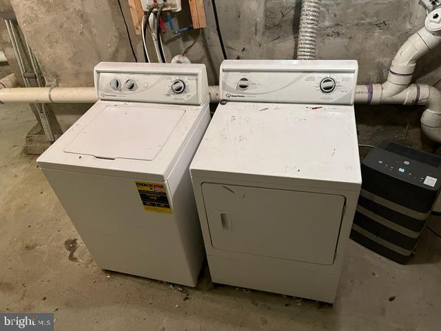 clothes washing area featuring washer and clothes dryer