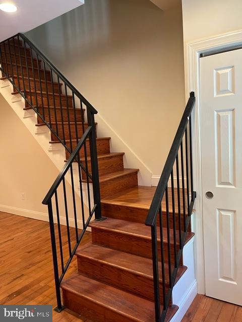 staircase featuring light wood-type flooring