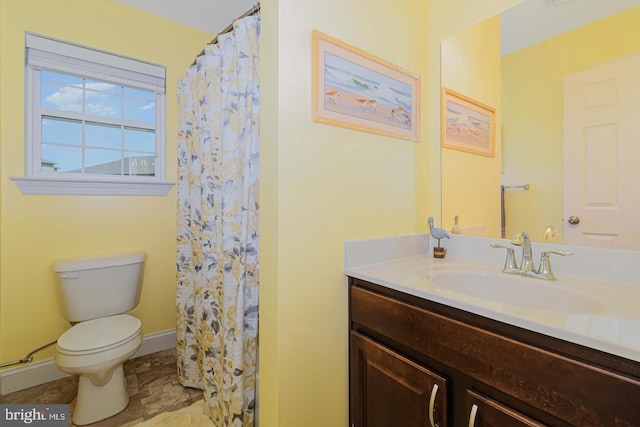 bathroom featuring walk in shower, vanity, and toilet