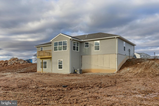 back of house with a balcony and central air condition unit