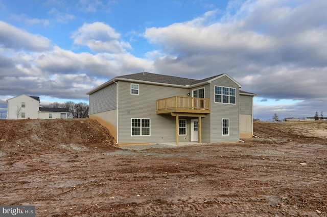 rear view of property featuring a wooden deck