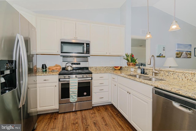 kitchen featuring hanging light fixtures, sink, stainless steel appliances, and lofted ceiling