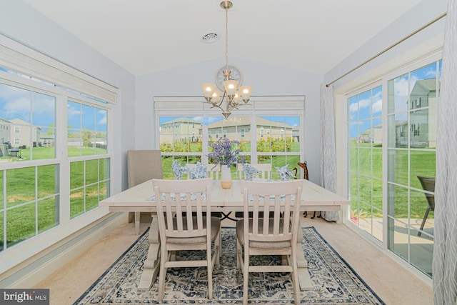 sunroom featuring lofted ceiling and an inviting chandelier