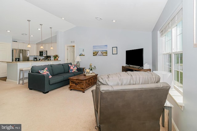 living room featuring light colored carpet and lofted ceiling