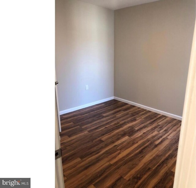 unfurnished room featuring dark hardwood / wood-style floors