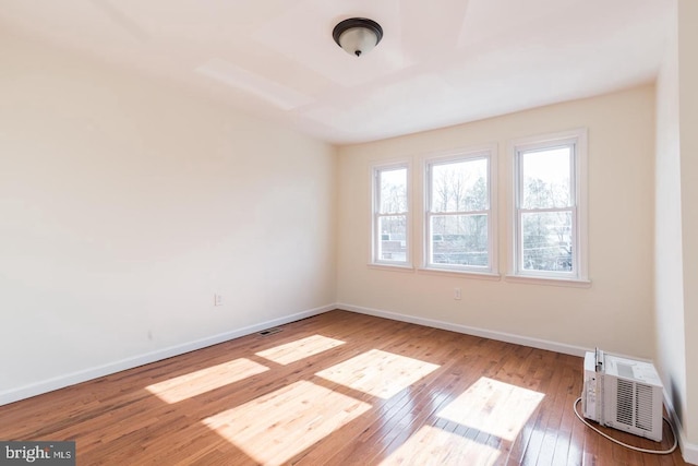 spare room with hardwood / wood-style floors