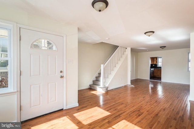 foyer with a healthy amount of sunlight and wood-type flooring