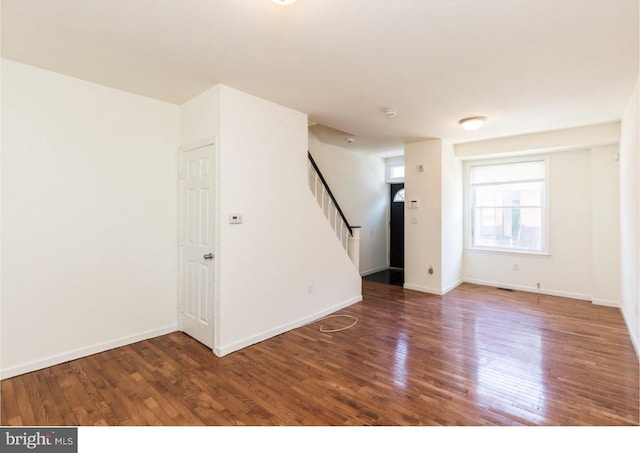 spare room with dark hardwood / wood-style flooring