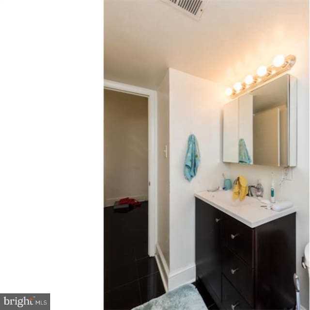 bathroom featuring tile floors and vanity