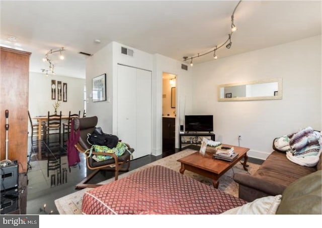 living room with concrete floors and track lighting