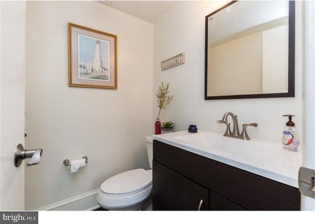 bathroom featuring toilet and large vanity