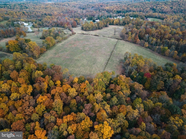 birds eye view of property featuring a view of trees