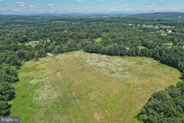 birds eye view of property featuring a view of trees