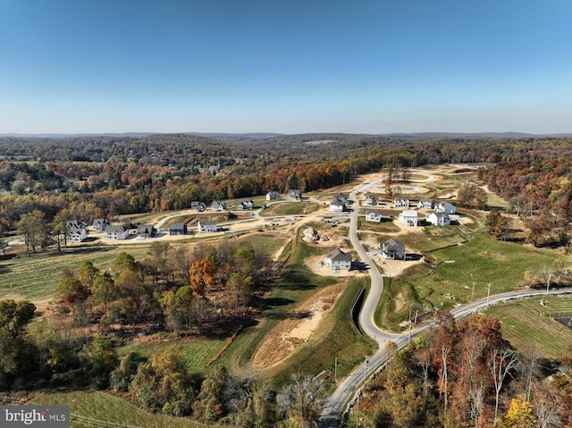 birds eye view of property with a view of trees