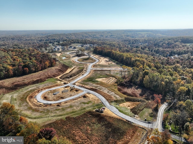 aerial view featuring a wooded view