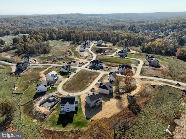 drone / aerial view with a wooded view