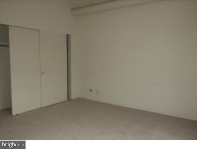 unfurnished bedroom with light colored carpet