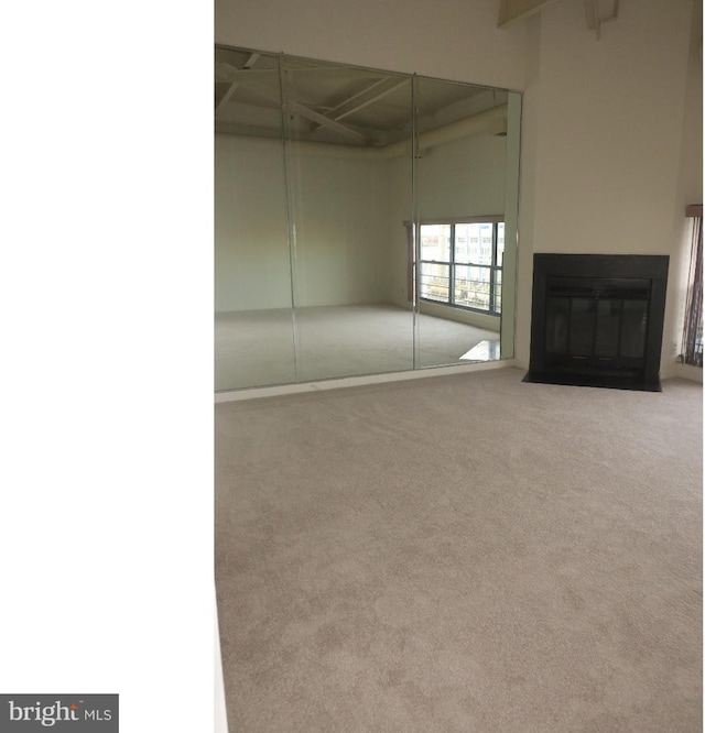 unfurnished living room with light carpet