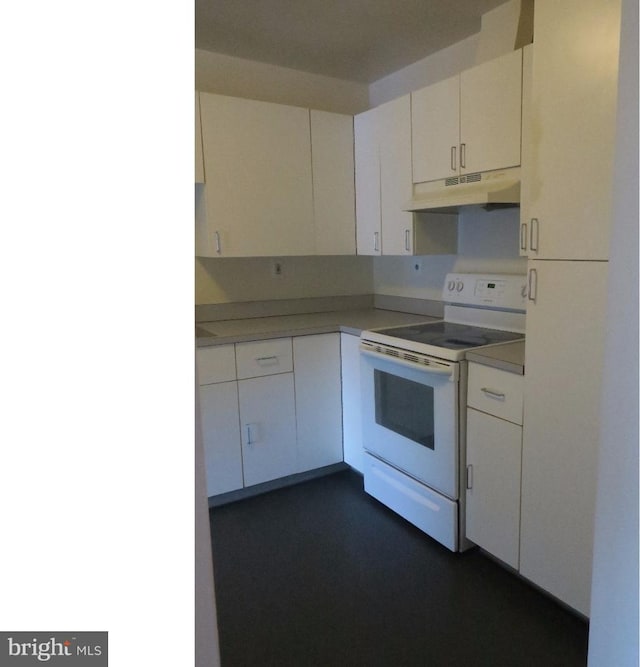 kitchen with electric stove and white cabinets