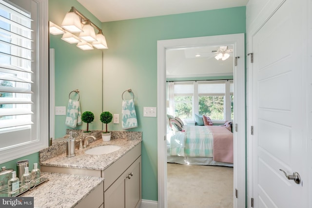 bathroom with ceiling fan and large vanity