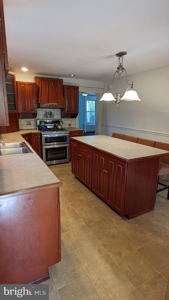 kitchen with premium range hood, decorative light fixtures, sink, a chandelier, and range with two ovens