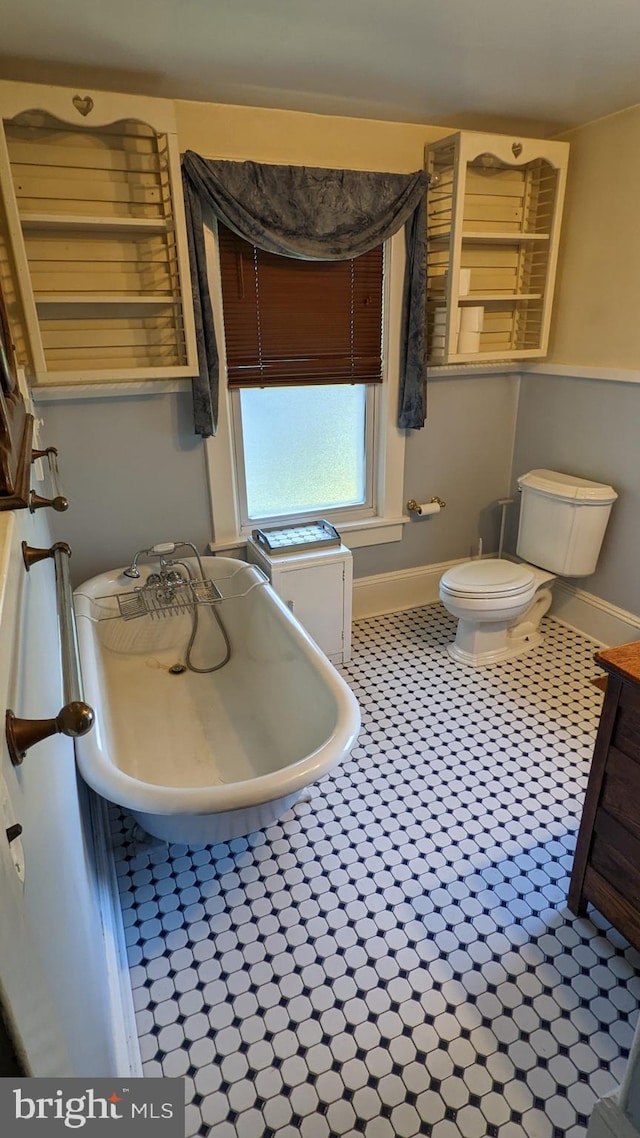 bathroom featuring toilet and tile flooring