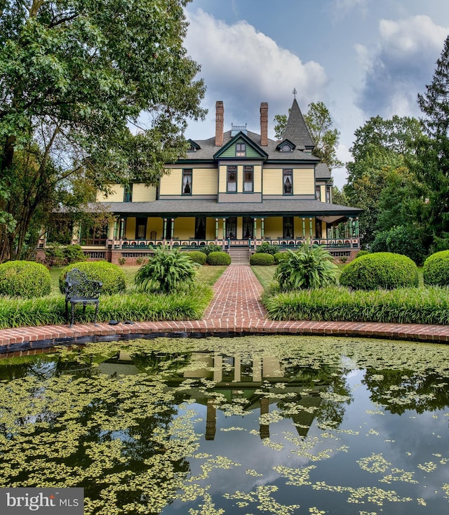 rear view of property featuring a water view