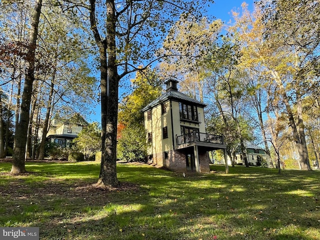 view of property exterior featuring a yard and a deck