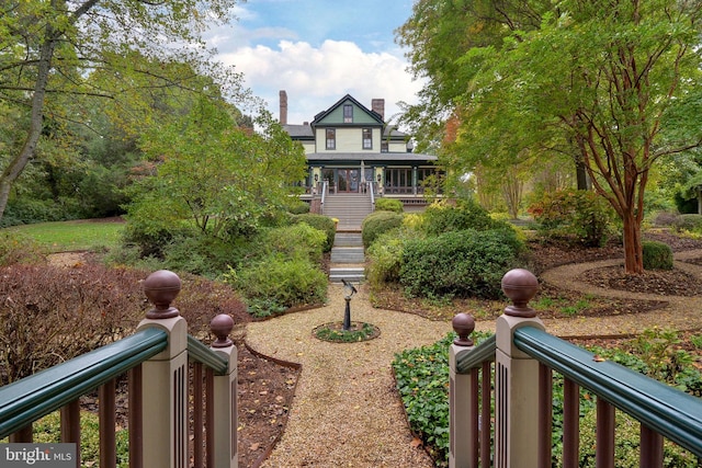 317 Coles Point Rd, Hague, VA 22469 - view of front facade featuring a chimney, covered porch, and stairs
