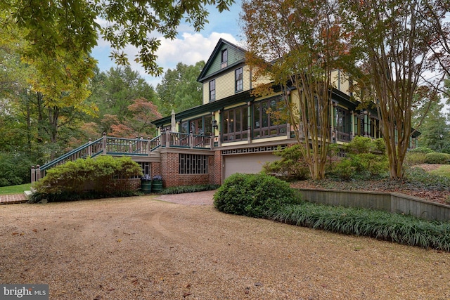 exterior space featuring a garage and a sunroom