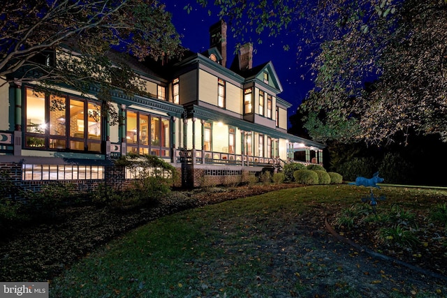 view of back house at twilight