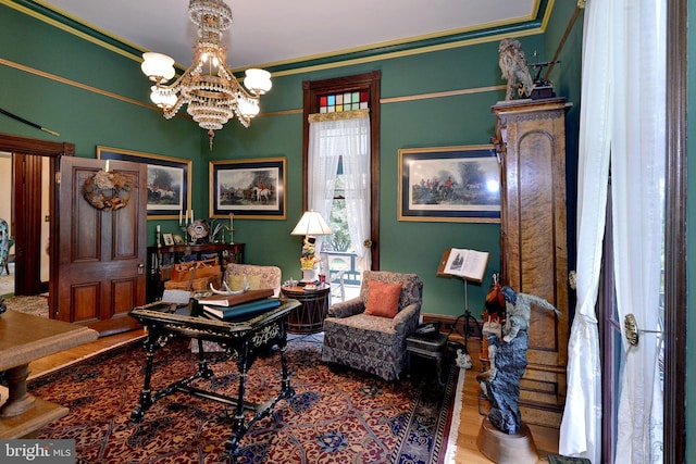 office space featuring a notable chandelier, wood-type flooring, and ornamental molding