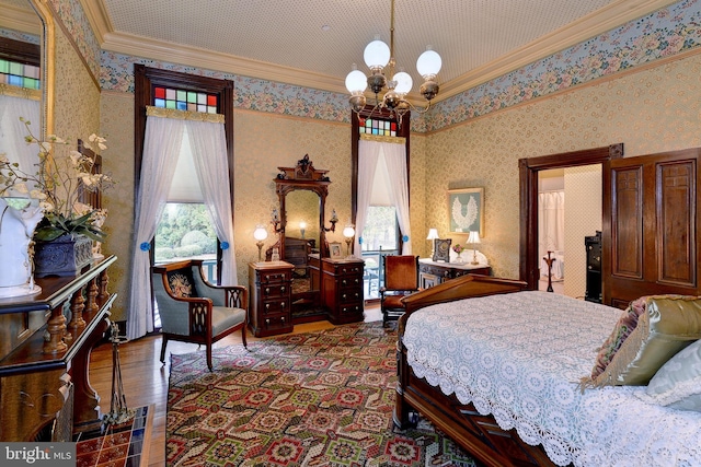 bedroom featuring a notable chandelier, crown molding, dark wood-type flooring, and multiple windows