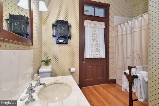 bathroom featuring hardwood / wood-style floors, vanity, and toilet