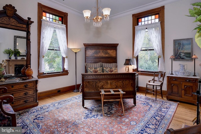 bedroom featuring multiple windows, crown molding, a notable chandelier, and light wood-type flooring