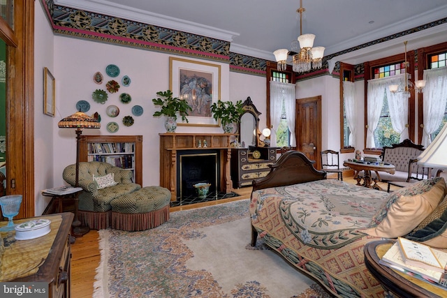 bedroom featuring an inviting chandelier, wood-type flooring, and ornamental molding