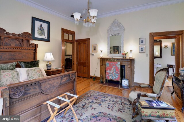 bedroom featuring light hardwood / wood-style floors, ornamental molding, and a chandelier