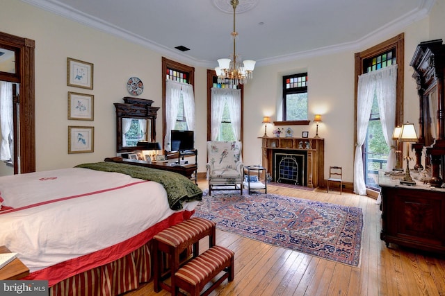 bedroom featuring light hardwood / wood-style floors, multiple windows, and ornamental molding