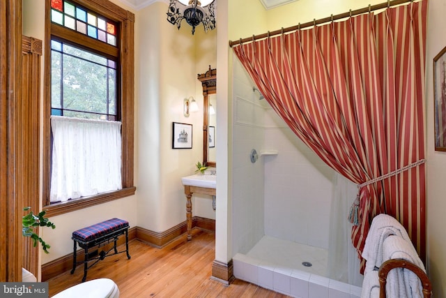 bathroom with a shower with curtain, a notable chandelier, crown molding, wood-type flooring, and toilet