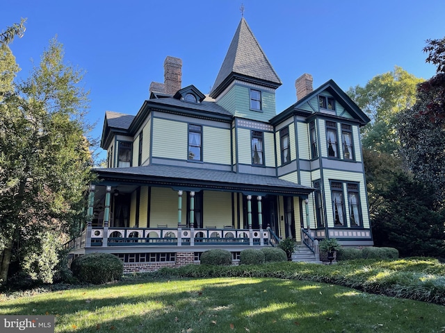 victorian-style house with a porch and a front yard