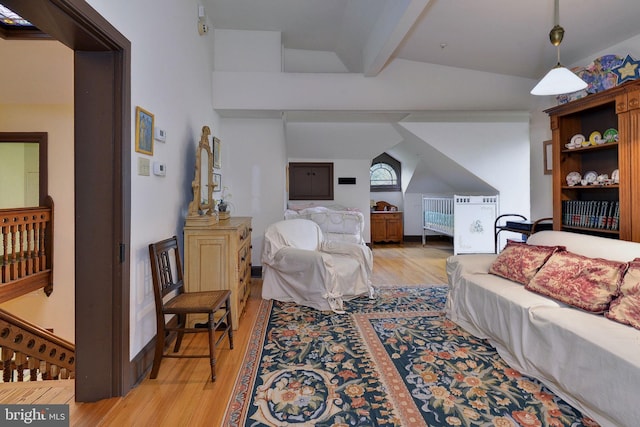 living room with lofted ceiling with beams and light hardwood / wood-style floors