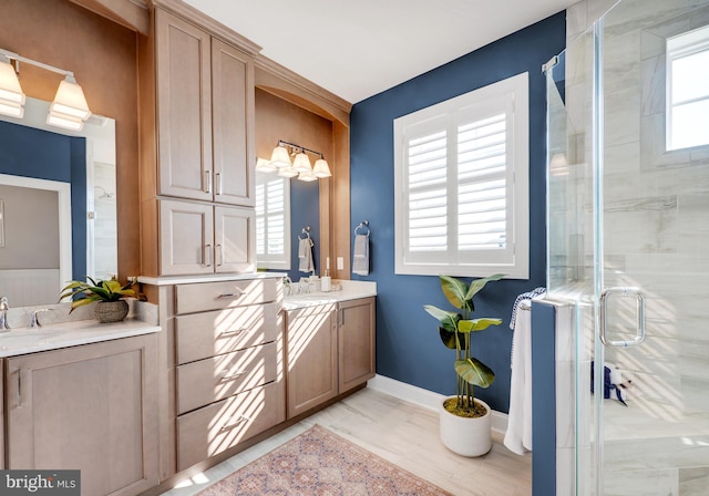 bathroom with an enclosed shower, oversized vanity, and dual sinks