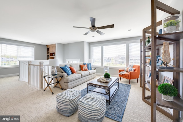 living room with ceiling fan and light colored carpet