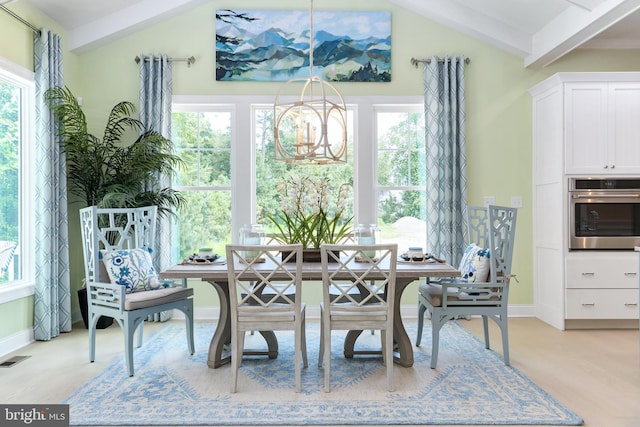 dining room with an inviting chandelier, a healthy amount of sunlight, and lofted ceiling with beams