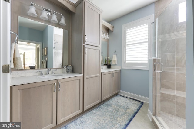 bathroom with a shower with door, tile floors, vanity, and plenty of natural light